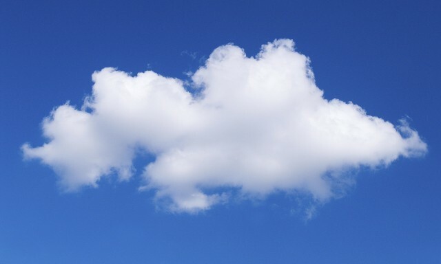 A single white cloud against a blue sky